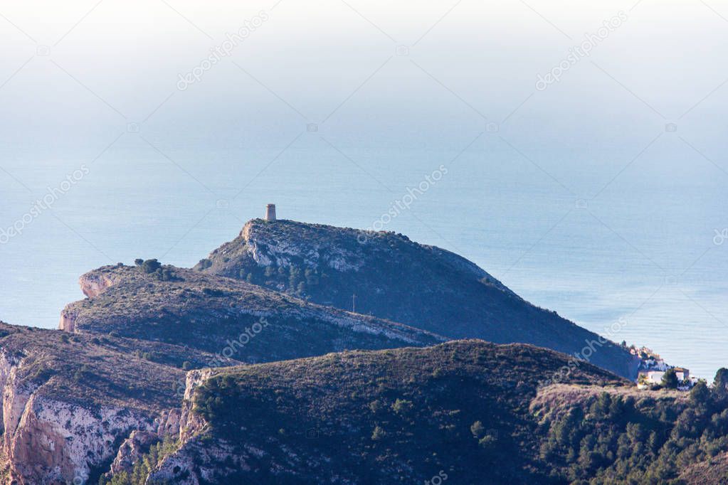 Panoramic view of Cap d'Or Tower in Moraira, Spain. View from Cumbre del Sol Mountain, also known as 