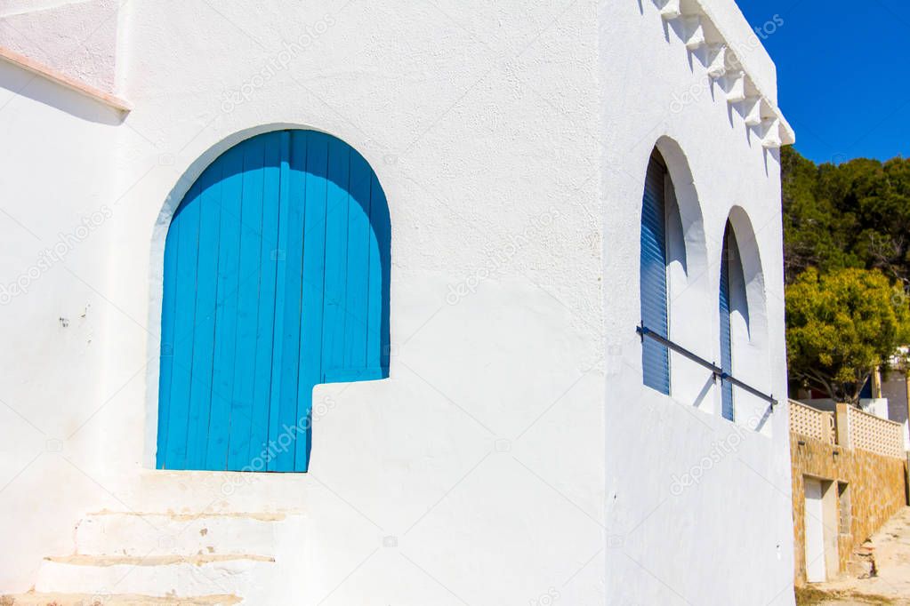 A typical mediterranean white and blue house, in Barraca Portitxol beach, in Javea, Spain