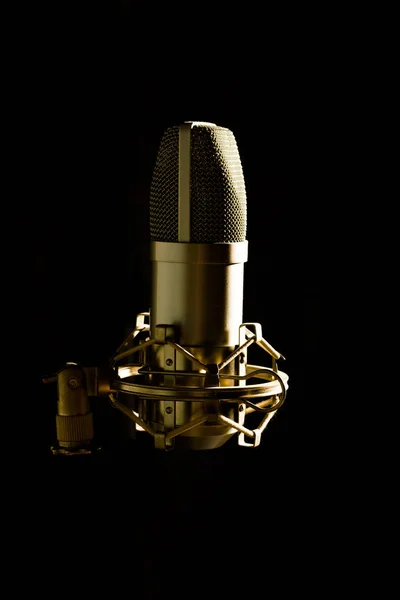 Studio microphone isolated on black background with side lightning — Stock Photo, Image