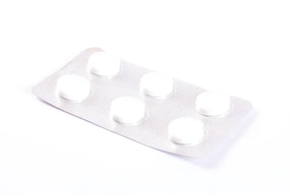 Белые таблетки в волдыре, изолированные на белом фоне — стоковое фото