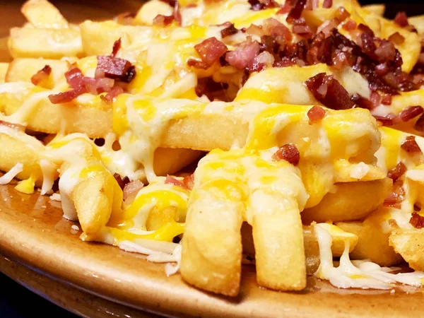 Close up of french fries with cheese sauce and bacon — Stock Photo, Image