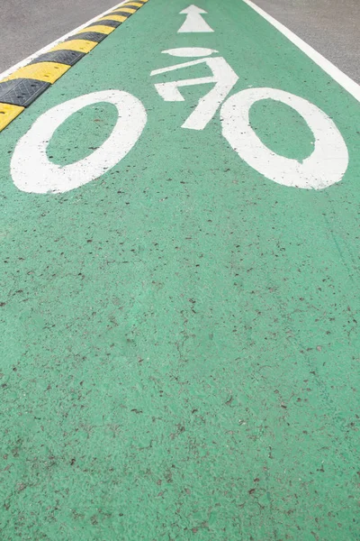 Bicycle signs on the bicycle way,   Bicycle lane on the green as