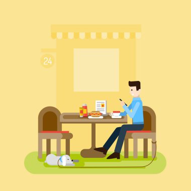 Bir adam ve bir köpek bir kafede oturan. 