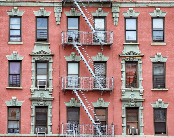 Red brick facade, and fire stairs. Harlem, NYC.