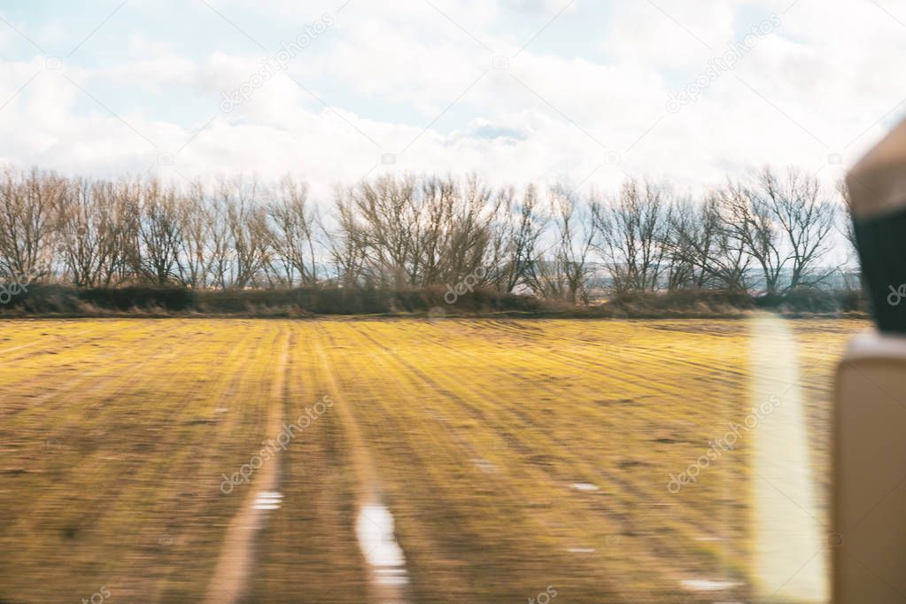 Melancholic concept of travel in autumn by train. View from the window.