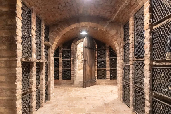 Old wine cellar with wine storage cases and open vintage wooden doors — Stock Photo, Image