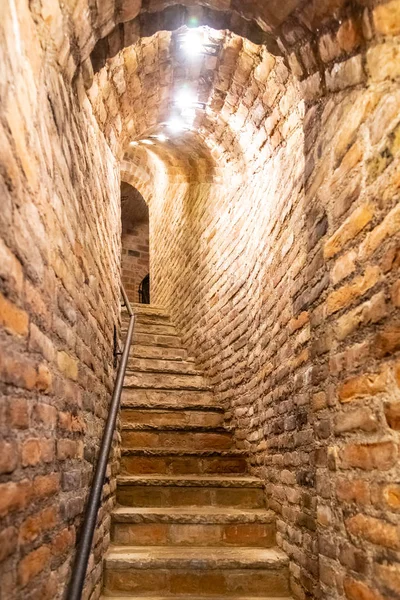 Narrow staircase in old cellar with brick walls — Stock Photo, Image