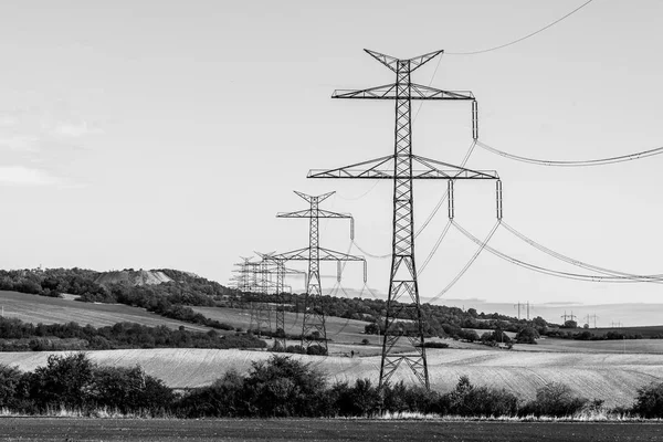 Line of transmission towers, or electricity pylons, in the rural landscape — Stock Photo, Image