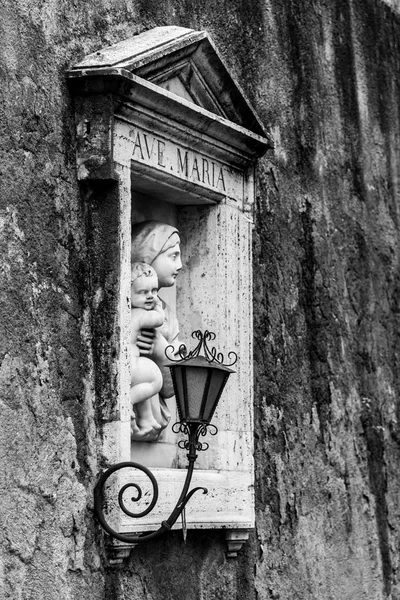 Muro callejero nicho religioso con pequeña escultura de María con Jesús —  Fotos de Stock