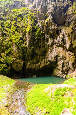 Macocha Abyss - large limestone gorge in Moravian Karst, Czech: Moravsky Kras, Czech Republic. View from bottom. clipart