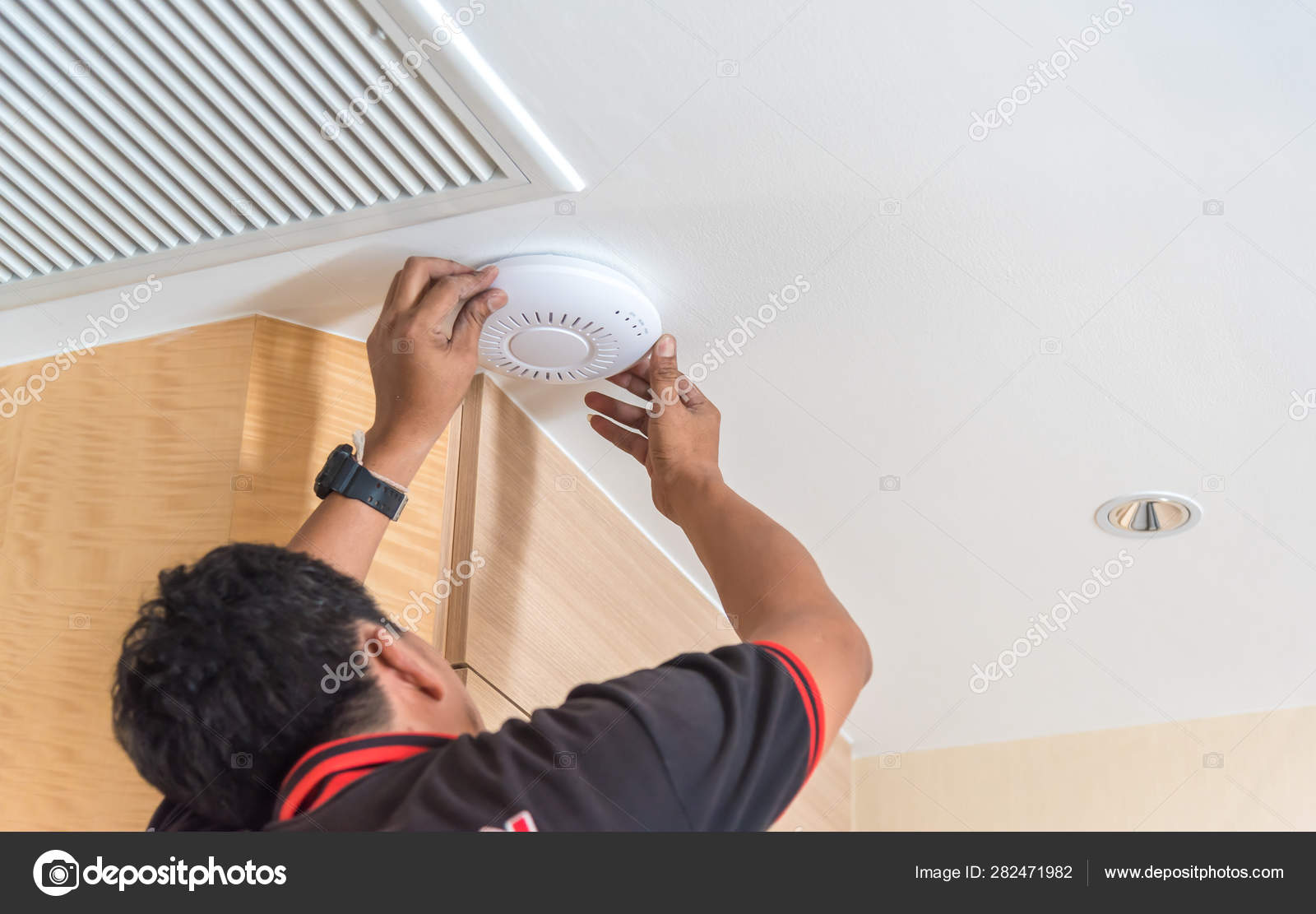 Technician Installing Ceiling Speaker Hotel Cordless Battery Drill