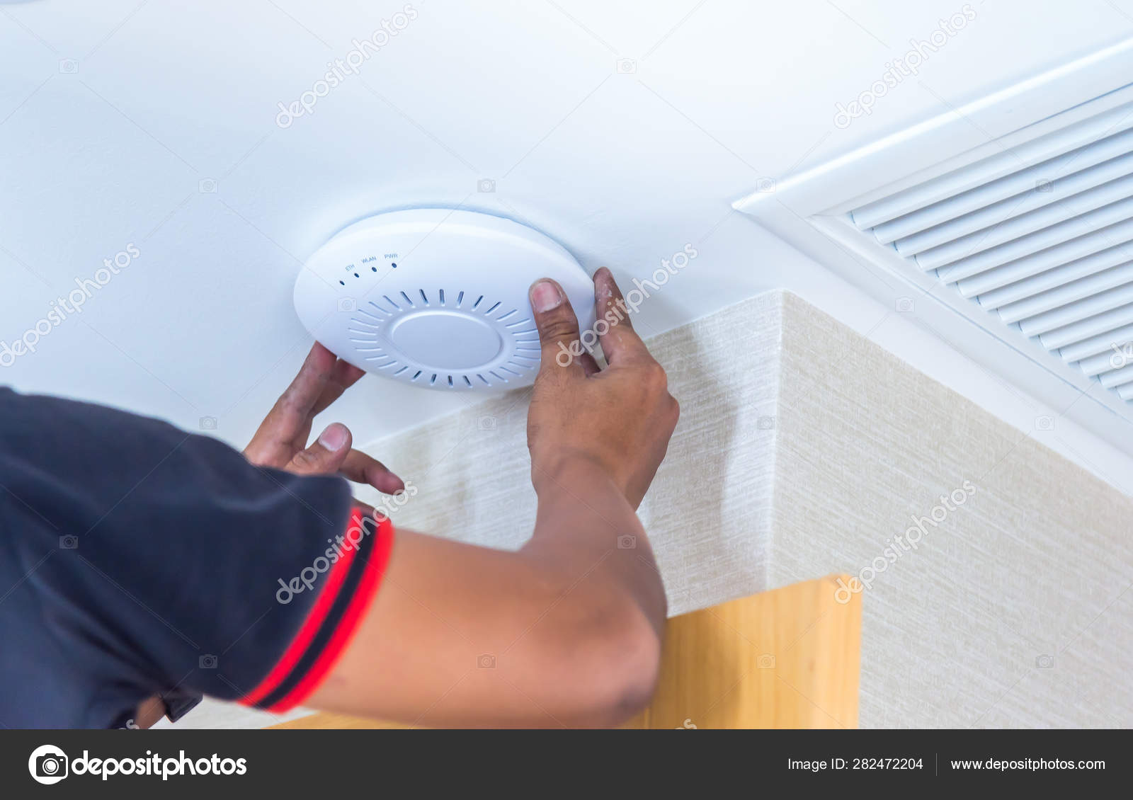 Technician Installing Ceiling Speaker Hotel Cordless Battery Drill
