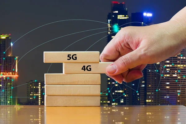 Close up hand putting domino 5G under 4G .That showing developed of best internet connection 5G is network connecting technology future global change from 4G to 5G system concept.