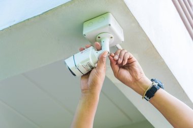 Teknisyen su veya yağmurdan cctv koruma için su geçirmez beyaz plastik kutu ile el tornavida ile kablosuz Cctv güvenlik kamerası yükleme.