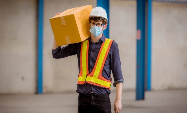 Portrait workers under inspection and checking production mask manufacture process on station by wearing safety mask to protect for pollution and virus in factory