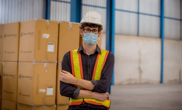 Portrait workers under inspection and checking production mask manufacture process on station by wearing safety mask to protect for pollution and virus in factory