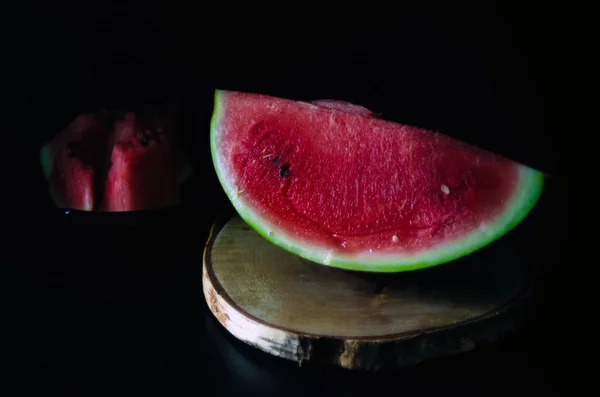 In Scheiben geschnittene saftige reife Wassermelone auf dunklem Hintergrund für das Menü — Stockfoto