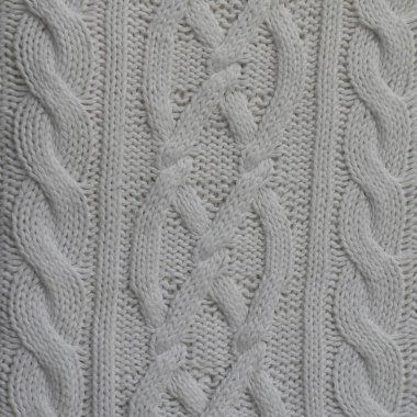 El yapımı beyaz örgü yün kumaş doku. Soyut örgü desenleri arka plan.