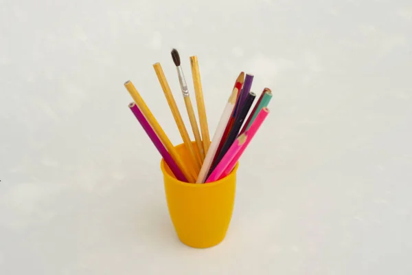 yellow glass pencil case with pencil and pen