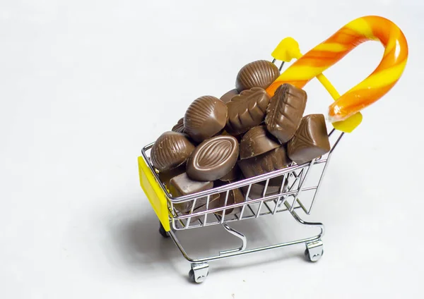 chocolate pieces in shopping cart isolated on white background