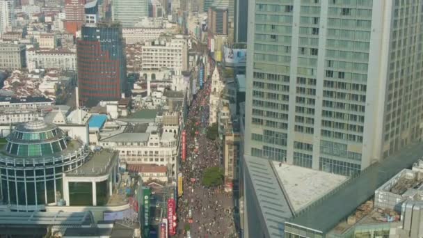 SHANGHAI, CHINA - 20 DE MARZO DE 2018: Nanjing Road. Calle peatonal en el distrito de Huangpu. La gente se agolpa. Vista aérea. Drone vuela hacia arriba, inclina hacia abajo — Vídeo de stock