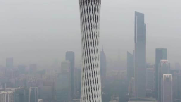 GUANGZHOU, CHINA - MARCH 25, 2018: Canton Tower and City Skyline in Smog in the Morning. Aerial Shot. Drone is Orbiting Clockwise. Closeup View — Stock Video