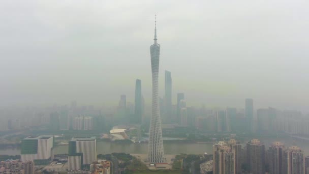 广州，中国 - 2018年3月25日：广州塔和城市天际线在烟雾在早晨。鸟瞰。无人机飞向上，向下倾斜 — 图库视频影像