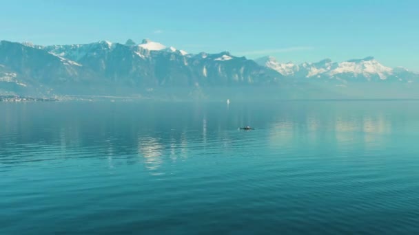 Two Men Kayaking on Clear Day on Blue Lake Geneva. Swiss Alps, Switzerland — Stock Video