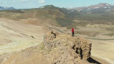Man Stands on Mountain Top. Iceland. Aerial View