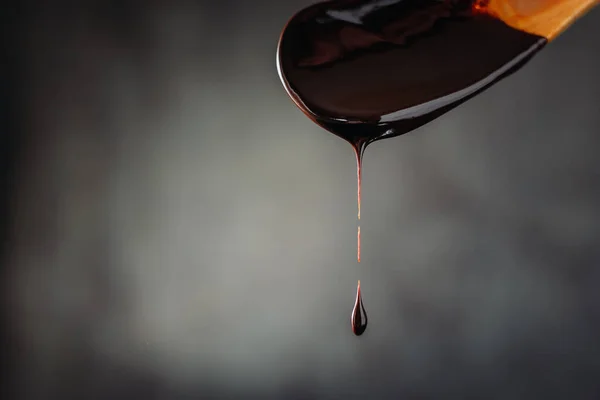 drop of hot chocolate on wooden spoon