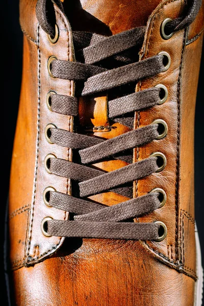 Close up of men's brown leather shoe. Lacing on shoes
