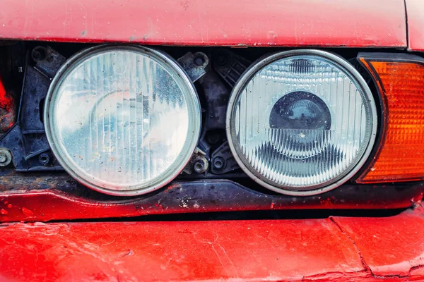 Close up of detail of front headlight of old red car — Stock Photo, Image