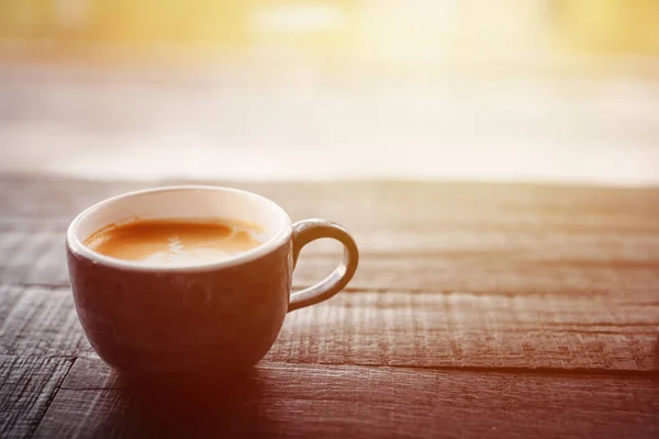 Tasse à café avec latte art mousse sur table en bois noir près de la fenêtre, fermer — Photo