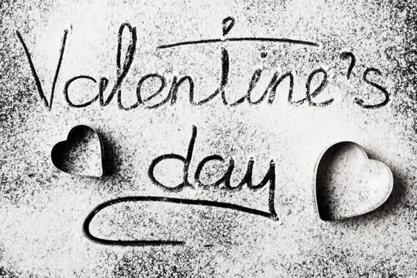 Inscription Valentines Day on a wheat flour background top view — Stock Photo, Image