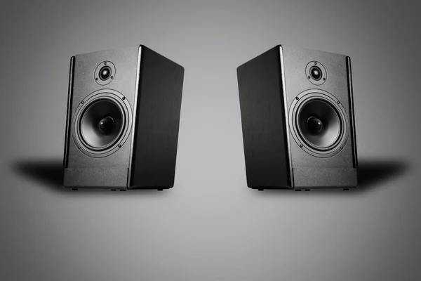 Two sound speakers on a gray background