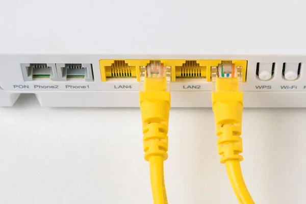 Home wireless router with ethernet cables plugged in, closeup — Stock Photo, Image