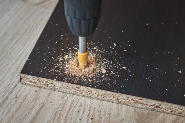 drillig wood with drill bit, wooden processing closeup