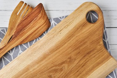 Mutfak eşyaları, kesme tahtası, spatula ve Beyaz ahşap zemin üzerinde havlu