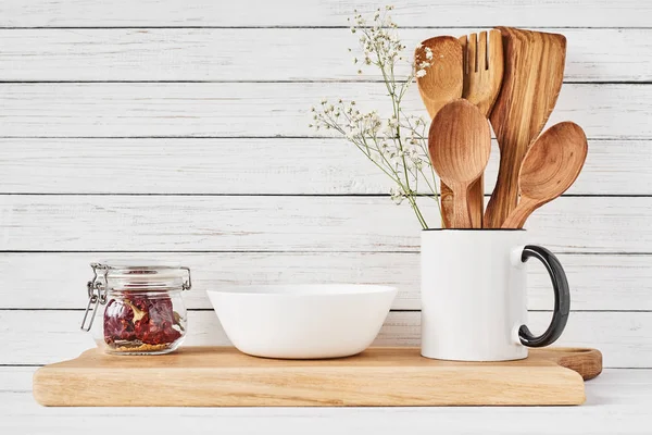 Kitchen tools and cutting board on white table