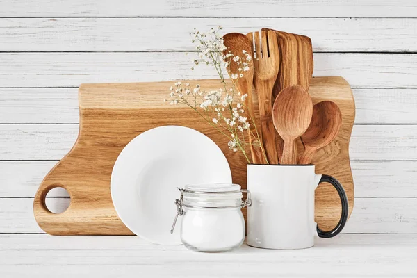 Kitchen tools and cutting board on white table — Stock Photo, Image