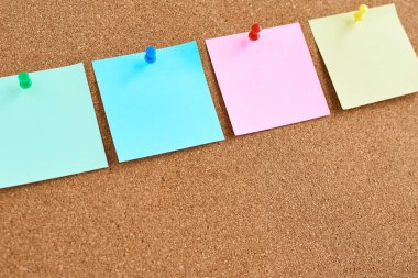 Sabitlenmiş renkli boş notlarla mantar tahtası