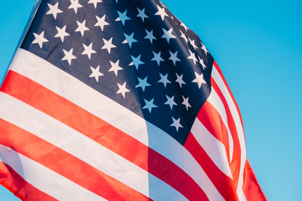 American flag in a blue sky, close up. Symbol of Independence Da