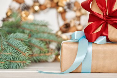 Beyaz arka plan üzerinde bir kraft kağıt ve noel süslemeleri sarılmış kurdele ile Noel hediyesi