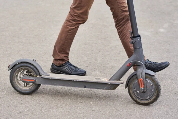 Şehirde elektrikli scooter kullanan adamın yakın çekim