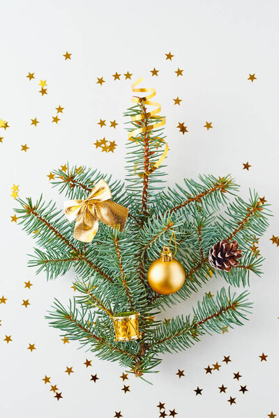 Christmas tree decorated with golden balls and christmas toys on