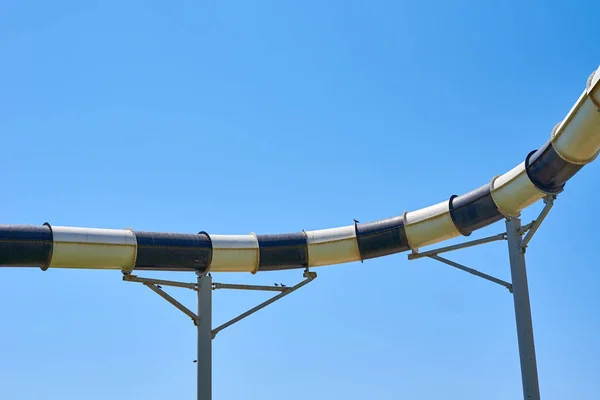 Close up of a tube water slide in aqua park against blue sky — Stock fotografie