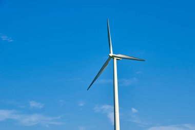 Mavi gökyüzüne karşı rüzgar türbini. Rüzgar enerjisi konsepti. İklim koruma için yenilenebilir enerji