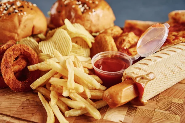 Unhealthy and junk food. Different types of fast food on the table, close up