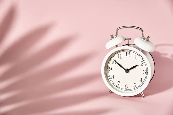 White Alarm Clock Leaves Shadows Pastel Pink Background Creative Minimal — Stock Photo, Image