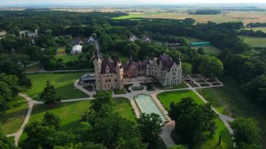 Moszna castle near Opole in Poland. Aerial view of historic castle surrounded by green park. European heritage and architecture